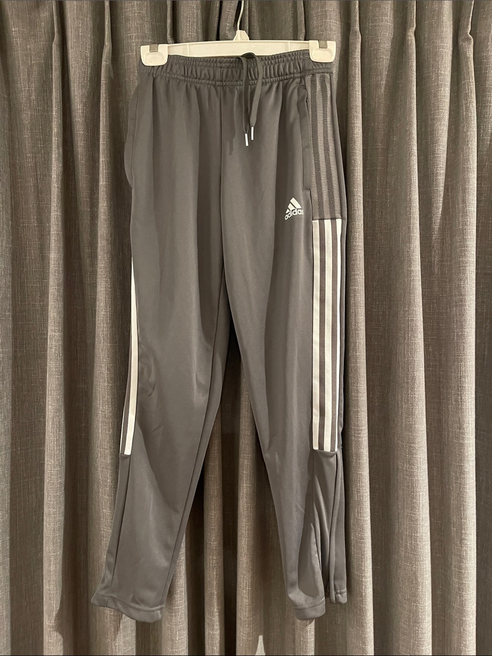 adidas Charcoal Gray Track Pants with White Three Stripes.
